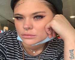She has several tattoos and piercings in her ears and nose.
